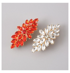 Close-up of alloy hair clip with red and white marquise-cut crystals on gold base