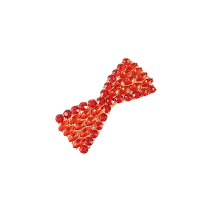 Elegant gold bow hair clip with sparkling red rhinestones in a crystal design