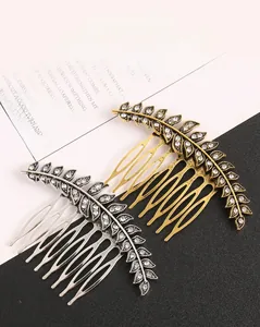 Detail of vintage leaf-shaped hair combs in gold and silver finish with sparkling rhinestones