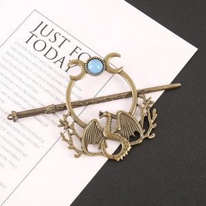Vintage bronze hair stick set with dragon motif and blue stone on white background