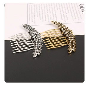 Detailed macro view of gold and silver alloy leaf hair combs with sparkling rhinestones