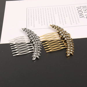 Set of vintage leaf hair combs in gold and silver alloy with sparkling rhinestones