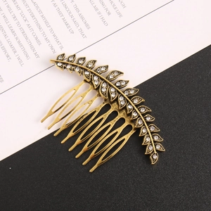 Vintage gold leaf hair comb with sparkling rhinestones for elegant bridal styling