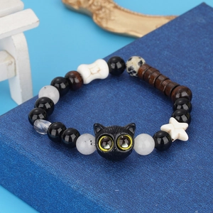 Cute black cat beaded bracelet with cheese and bone charms on a blue display box
