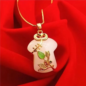 Detail of cheongsam jade pendant with gold inlay on red velvet background