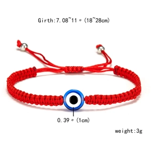 Detail of red woven turtle bracelet with blue evil eye bead and adjustable drawstring