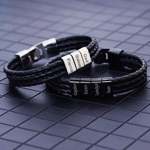 Close-up of woven leather men's bracelets with custom engraved stainless steel name beads