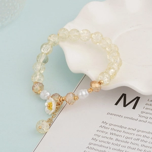 Colorful beaded crystal bracelet with white daisy charm and elegant pearl accents