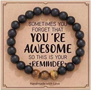 Matte black stone beaded bracelet with tiger eye accents on inspirational gift card