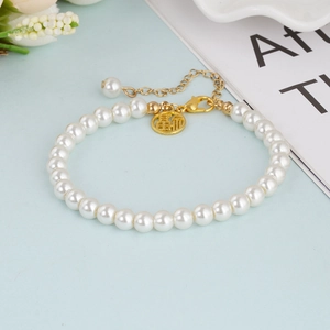 Vintage French pearl bracelet with a golden Fu pendant and adjustable lobster clasp closure