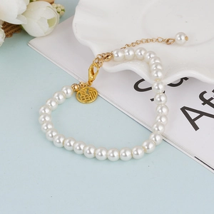 Vintage French pearl bracelet with gold Fu character pendant and lobster clasp