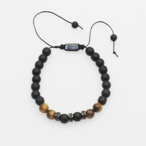 Detailed close-up of tiger eye beads and matte black stones on a braided cord bracelet
