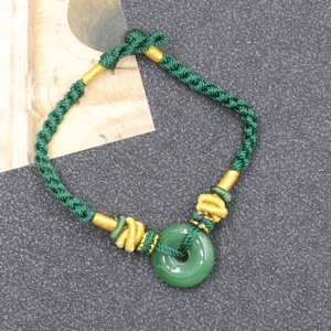 Handmade green braided bracelet with Hetian jade donut pendant and gold silk accents