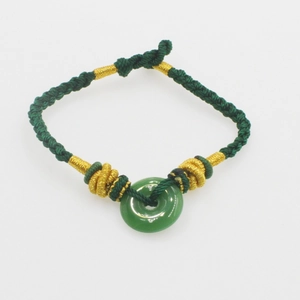 Handwoven dark green silk bracelet with Hetian jade donut pendant and gold thread accents