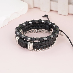 Detail of punk style braided leather bracelet with beads and adjustable silver buckle