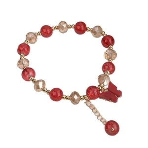 Red crackle bead bracelet with butterfly pendant and gold accents on white background