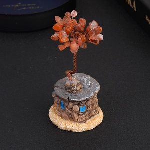 Handcrafted gemstone money tree with orange crystal leaves and vintage stone house base