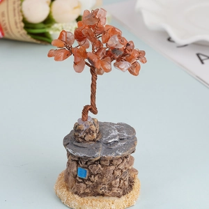 Handmade crystal tree of life with carnelian leaves on a vintage stone house base