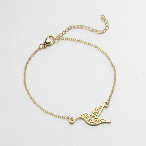 Close-up of golden hummingbird charm bracelet with adjustable lobster clasp chain