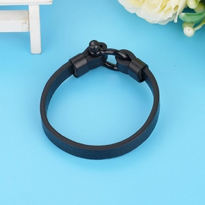 Detail of lychee textured black leather bracelet with U-shaped stainless steel shackle clasp