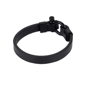 Macro detail of men's black lychee pattern leather bracelet with matte U-shaped shackle buckle