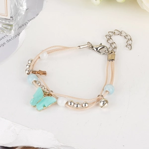 Braided nautical rope bracelet with turquoise butterfly charm and silver bell accent