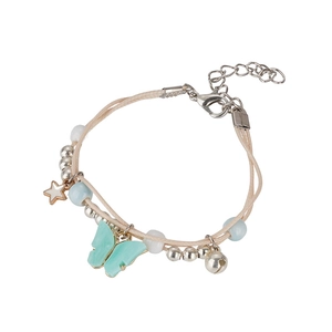 Detail of woven anchor bracelet featuring mint butterfly, gold star, and bell charms