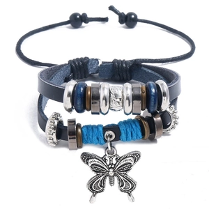 Detail of multi-layer leather bracelet with blue beads and a large alloy butterfly charm