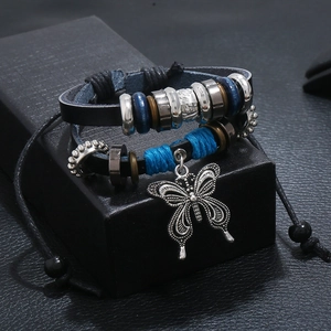 Handmade leather bracelet with bead accents and a vintage silver butterfly pendant