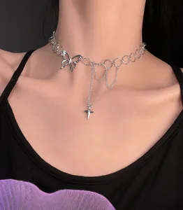 Detail of silver choker with butterfly pendant and star tassel fringe on neck