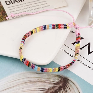 Detail view of colorful bohemian woven friendship bracelet with adjustable sliding knot design
