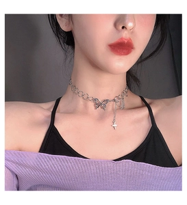 Silver butterfly choker with large metal rings and asymmetrical star tassel on a model