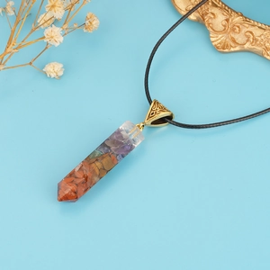 Colorful 7 Chakra natural stone resin pendant necklace with black cord on blue background