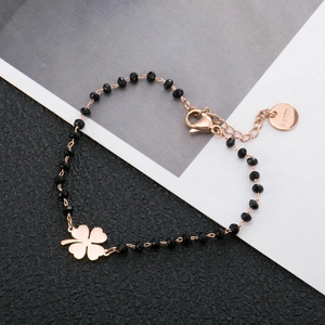 Rose gold stainless steel bracelet with black faceted beads and a clover charm