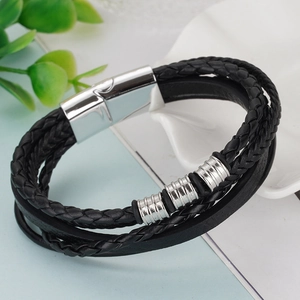 Detail of multi-layer braided leather bracelet with silver magnetic heartbeat clasp