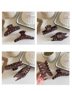Detail shots of large dark brown butterfly print hair claw clips with acrylic texture