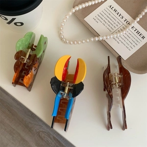 Detailed view of colorful acetate hair claws in animal shapes with smooth metal springs