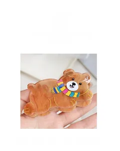 Detail of cute brown bear hair claw clip with colorful striped scarf and resin texture