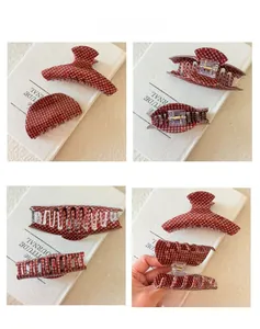 Detail shots of red plaid acrylic hair claws showing size and metal spring structure