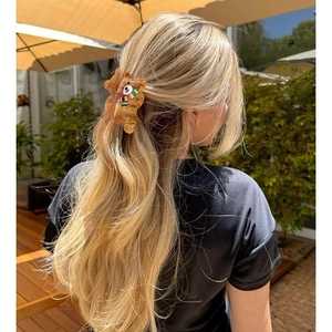 Brown teddy bear hair claw clip with colorful scarf shown in back view on long hair