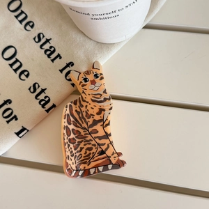 Close-up of leopard cat shaped acetate hair claw with detailed leopard print texture