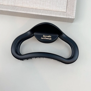Matte black cloud-shaped shark hair claw clip with golden lettering for thick hair