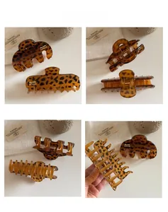 Detailed macro view of leopard print resin hair claws with Barrette LaFrance engraving