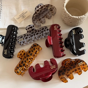Collection of elegant leopard print and solid color hair claws in various shapes and sizes