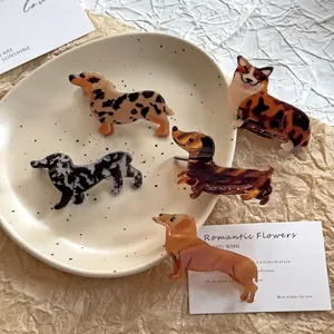 Five cute dog-shaped hair claws including dachshund and corgi in marble and tortoiseshell patterns