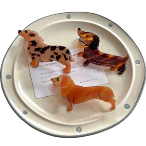 Three dachshund hair claws in assorted colors including cream spots and tortoiseshell patterns