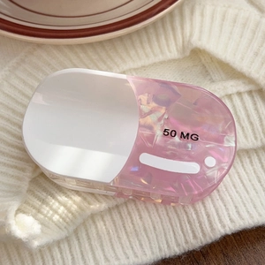 Detailed macro view of capsule shaped hair claw clip with 50 MG text and marble texture