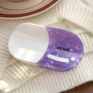 Detailed view of large oval pill-shaped hair claw clip in purple marble acetate with 50MG text