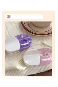 Close-up of capsule-shaped hair claw clips with 50 MG print on a soft knit background