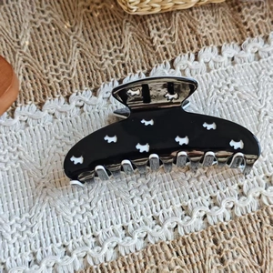 Polished black acetate shark hair claw with white Scottie dog pattern for thick hair